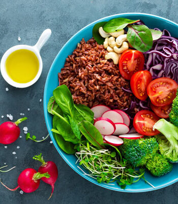 bowl of brown rice salad with a variety of vegetables