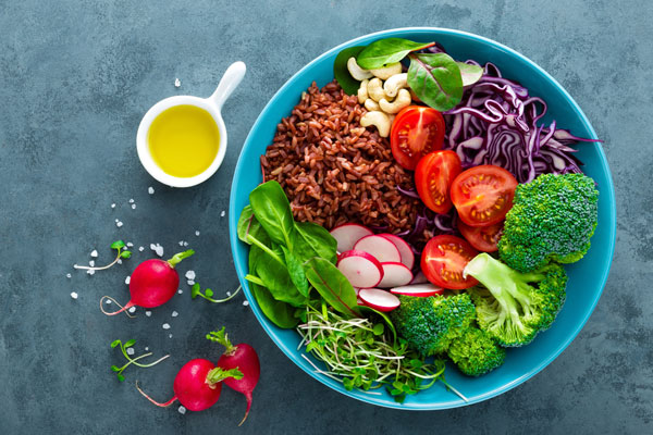 bowl of brown rice salad with a variety of vegetables