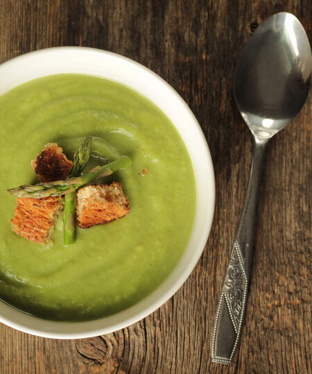 bowl of asparagus soup with serving spoon