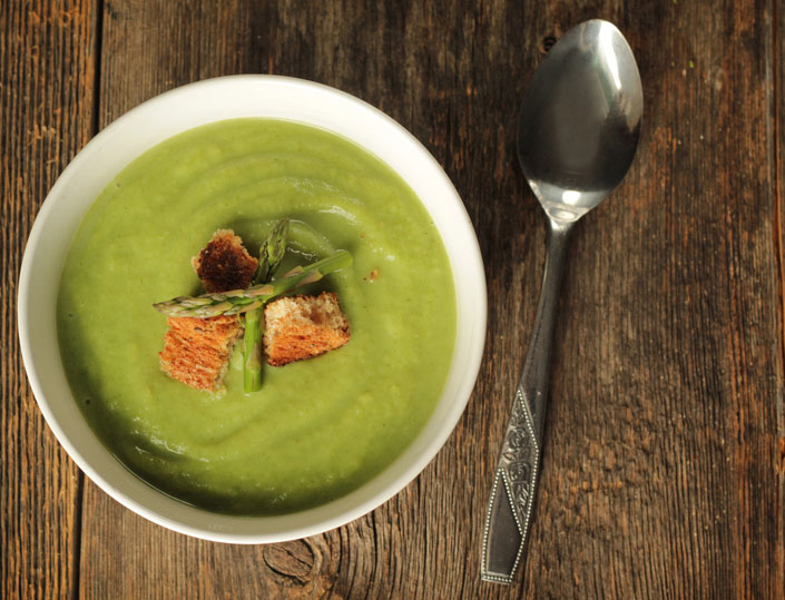 bowl of asparagus soup with serving spoon
