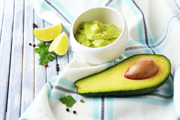 avocado, lime, and cup of avocado mayo.