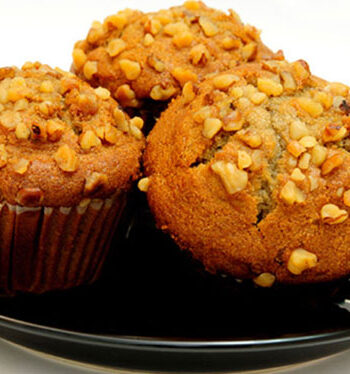 three banana nut muffins on a black plate