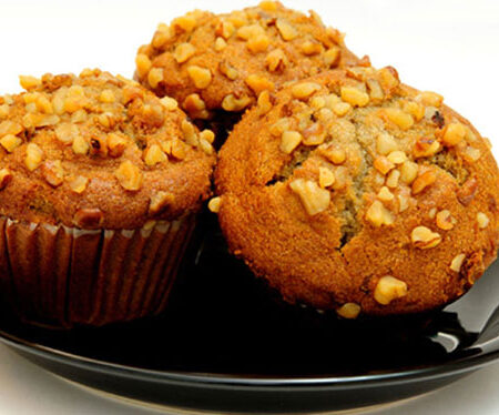 three banana nut muffins on a black plate