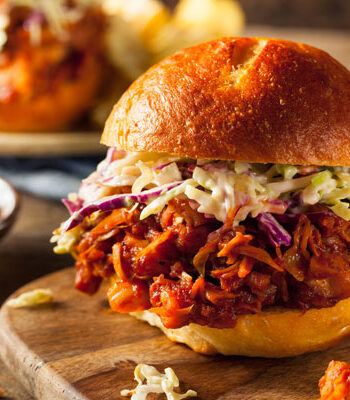 Barbecued Jackfruit Sandwich on a wood cutting board.