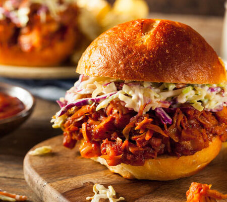 Barbecued Jackfruit Sandwich on a wood cutting board.