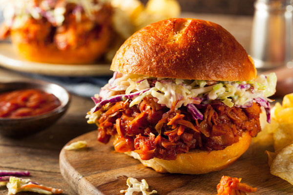 Barbecued Jackfruit Sandwich on a wood cutting board.