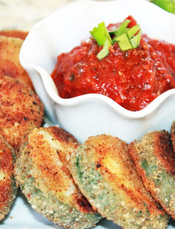 Crispy zucchini bites and a dish of marinara.
