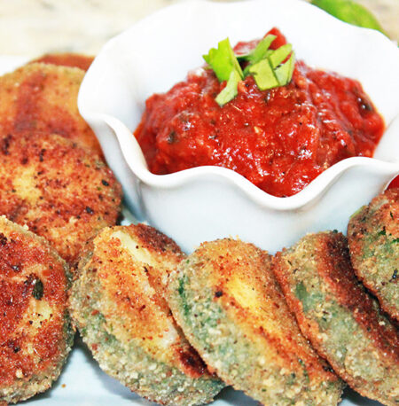 Crispy zucchini bites and a dish of marinara.