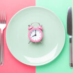 Place setting with a clock in the center of the plate.
