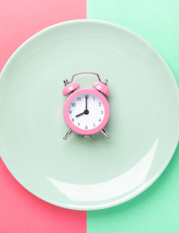 Place setting with a clock in the center of the plate.