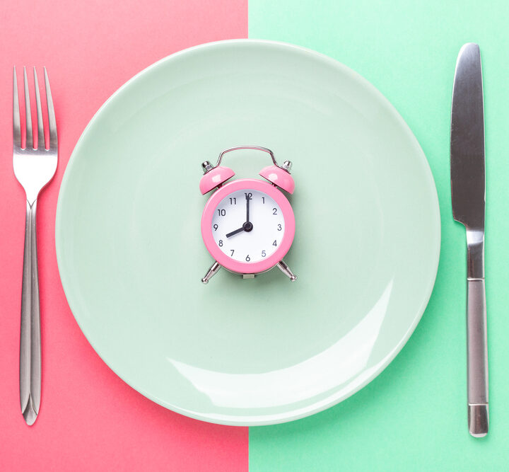 Place setting with a clock in the center of the plate.
