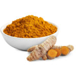 Fresh turmeric root next to a bowl of turmeric powder.