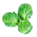 Three Brussels Sprouts on a white background.