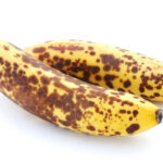 Two over-ripe bananas on a white background.