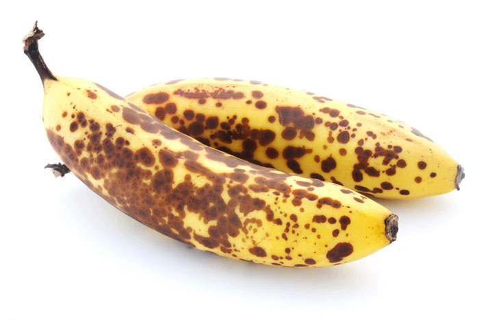 Two over-ripe bananas on a white background.