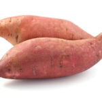 Two whole sweet potatoes on a white background.
