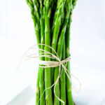 Asparagus spears tied with twine standing vertically