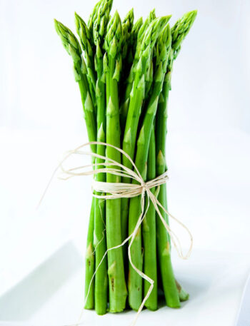 Asparagus spears tied with twine standing vertically