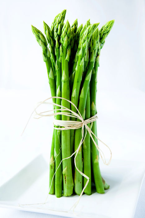 Asparagus spears tied with twine standing vertically