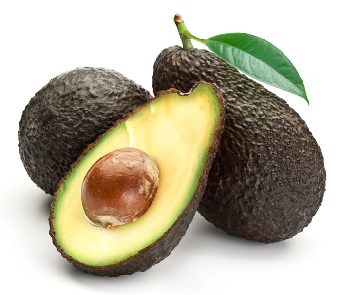 3 avocados on a white background with one avocado halved