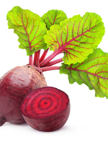 A whole beet with greens attached and a halved beet on a white background.