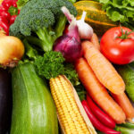A variety of colorful produce on a white background.