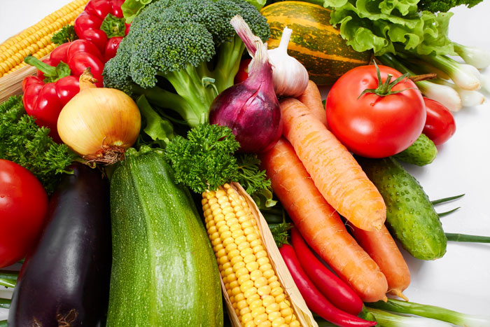 A variety of colorful produce on a white background.