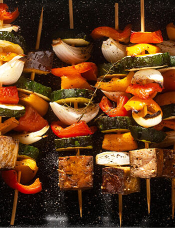 Cooked smoked tofu and vegetable skewers.