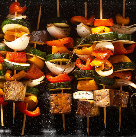 Cooked smoked tofu and vegetable skewers.