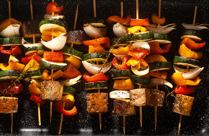 Cooked smoked tofu and vegetable skewers.