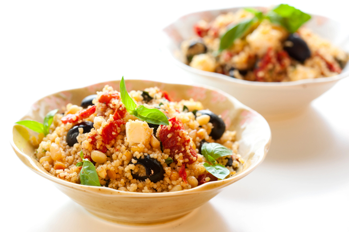 Two bowls of Mediterranean Couscous Salad on a white background.