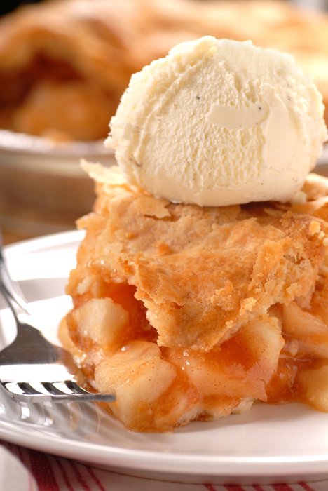 Deep Dish Apple Pear Pie on a plate with a scoop of vanilla ice cream on top.