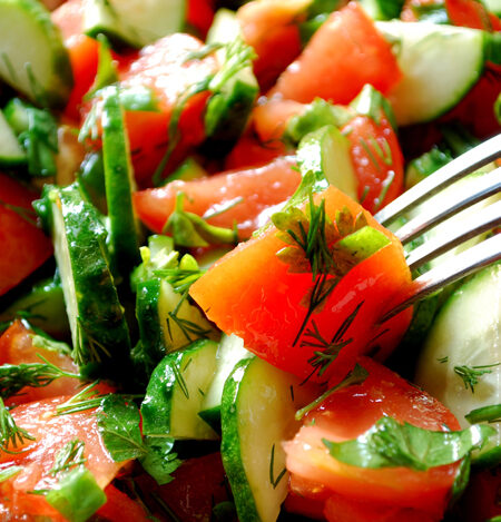 Close up of an Heirloom tomato salad and a salad fork.