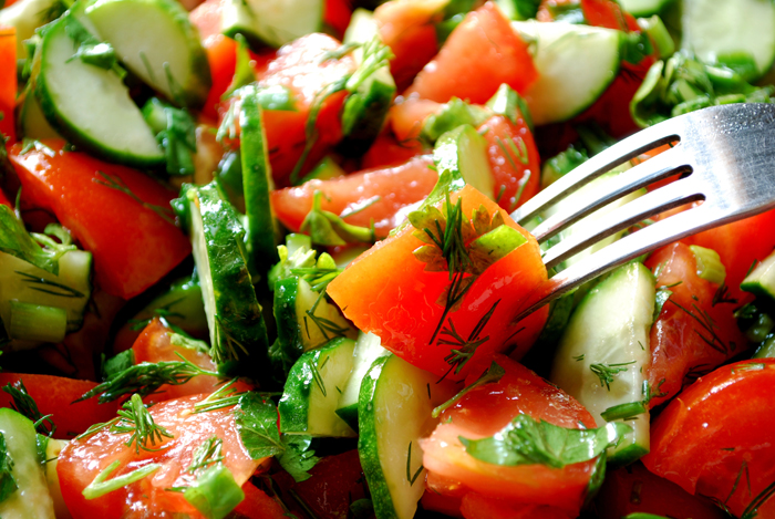 Close up of an Heirloom tomato salad and a salad fork.